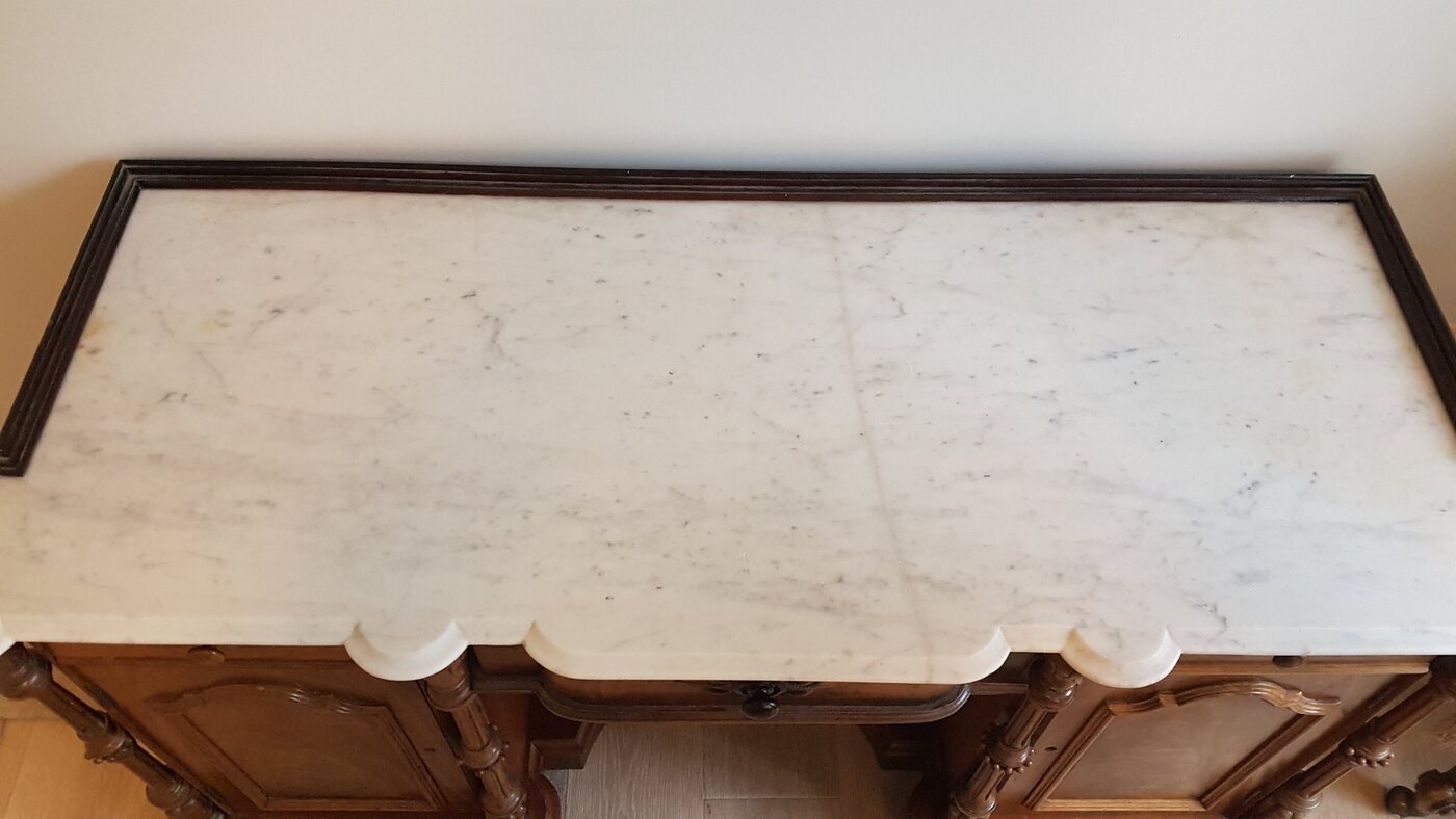 The same antique marble table after repair, cracks closed and the surface polished
