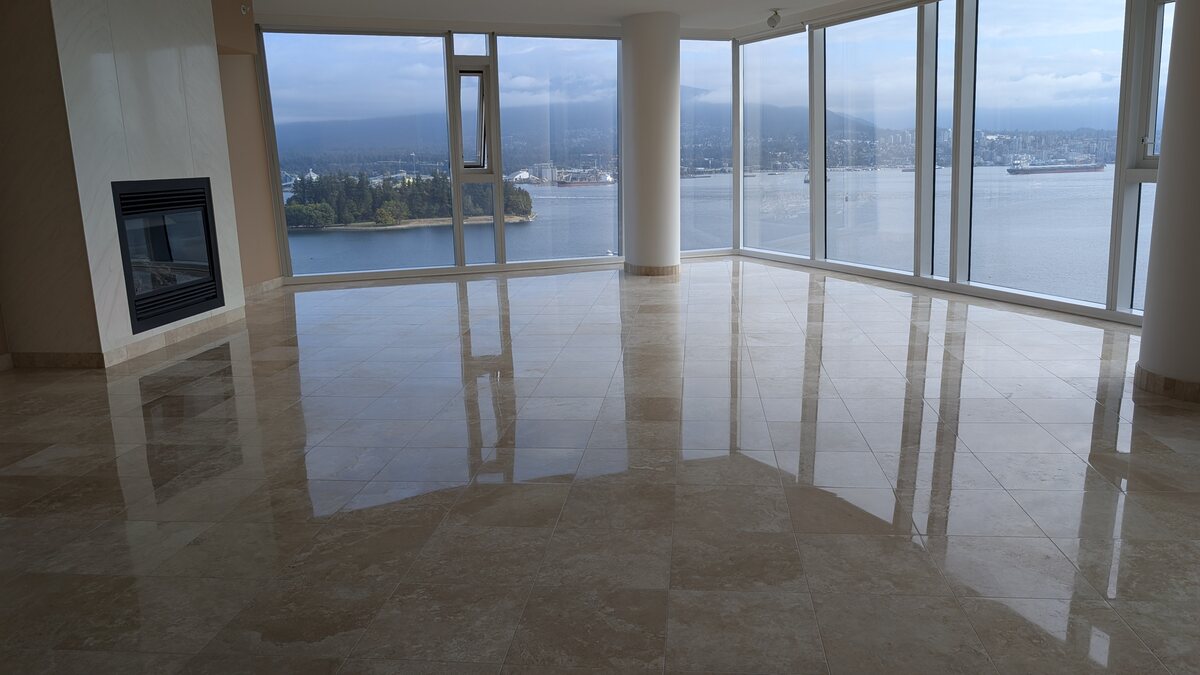 Mirror-polished stone floor in a Vancouver penthouse overlooking Coal Harbour