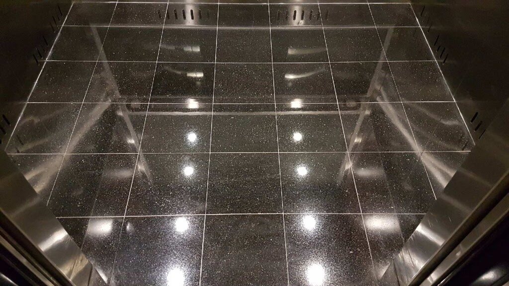 Restored granite elevator lobby floor in a Vancouver commercial building